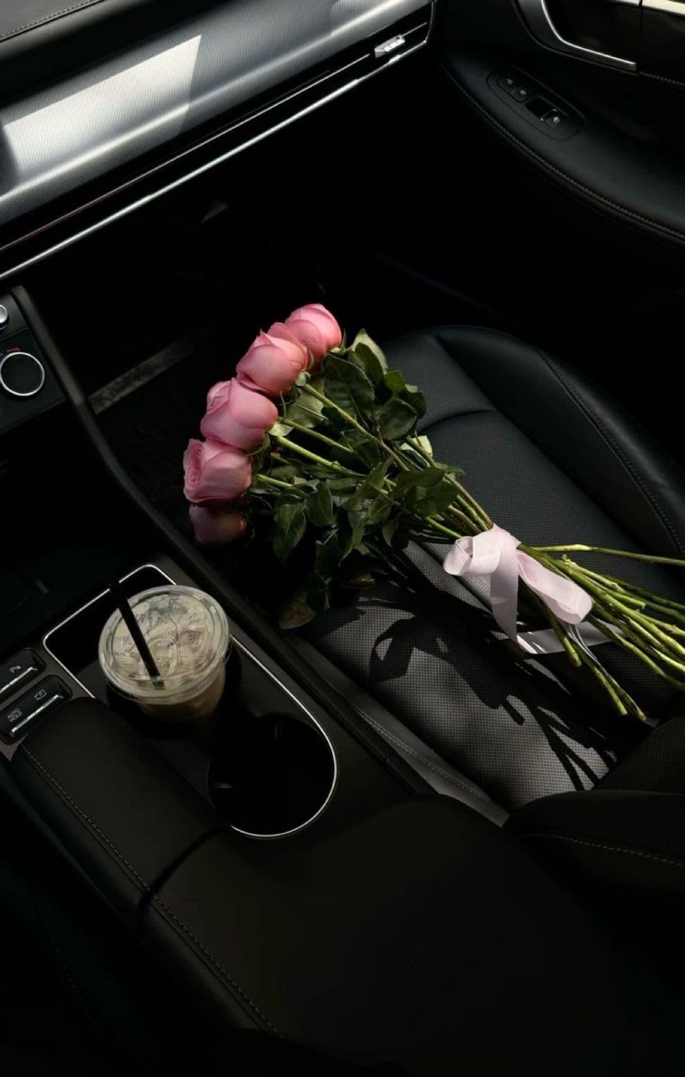 Rosas rosadas fotografiadas cerca del interior de un auto